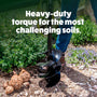 Person using a garden auger with text 'Heavy-duty torque for the most challenging soils' in a garden setting.